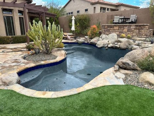 Custom Pool Remodel & Interior Renovation in Arizona - A successful pool remodel starts with understanding the existing structure and carefully preparing it for the improvements ahead. This Aqua Squad Pools & Landscaping project shows multiple stages of a residential pool renovation, giving homeowners a look at the work that happens before the finished pool is ready to enjoy.
The project began with an existing freeform pool surrounded by natural stone, mature desert landscaping, and integrated backyard features. During the remodel, the pool was drained and the existing interior was chipped out to prepare the surface for renovation.
The project also included modifications to the pool’s built-in bench area. The construction photos show the bench being raised and reinforced as part of the remodeling process. Once the preparation and structural work were completed, a new pool interior was installed and progressed through the finishing process, including the pre- and post-acid-wash stages shown here.
Pool remodeling is about more than changing how a swimming pool looks. Existing features, elevations, steps, benches, surrounding hardscape, landscaping, and the overall backyard design all need to be considered when planning an update.
Aqua Squad Pools & Landscaping helps Arizona homeowners transform existing pools and outdoor spaces with pool remodeling, pool construction, landscape design, water features, and other backyard improvements. Whether your pool needs an updated interior or you’re considering a larger backyard redesign, our team can help you explore options that work with your existing property.
Planning a pool remodel in Arizona? Contact Aqua Squad Pools & Landscaping to discuss your pool and backyard renovation. Custom Pool Remodel & Interior Renovation in Arizona - A successful pool remodel starts with understanding the existing structure and carefully preparing it for the improvements ahead. This Aqua Squad Pools & Landscaping project shows multiple stages of a residential pool renovation, giving homeowners a look at the work that happens before the finished pool is ready to enjoy.
The project began with an existing freeform pool surrounded by natural stone, mature desert landscaping, and integrated backyard features. During the remodel, the pool was drained and the existing interior was chipped out to prepare the surface for renovation.
The project also included modifications to the pool’s built-in bench area. The construction photos show the bench being raised and reinforced as part of the remodeling process. Once the preparation and structural work were completed, a new pool interior was installed and progressed through the finishing process, including the pre- and post-acid-wash stages shown here.
Pool remodeling is about more than changing how a swimming pool looks. Existing features, elevations, steps, benches, surrounding hardscape, landscaping, and the overall backyard design all need to be considered when planning an update.
Aqua Squad Pools & Landscaping helps Arizona homeowners transform existing pools and outdoor spaces with pool remodeling, pool construction, landscape design, water features, and other backyard improvements. Whether your pool needs an updated interior or you’re considering a larger backyard redesign, our team can help you explore options that work with your existing property.
Planning a pool remodel in Arizona? Contact Aqua Squad Pools & Landscaping to discuss your pool and backyard renovation.