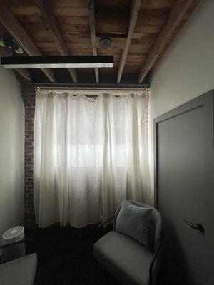 Curtain rods - Installed curtain rods in an office on a wooden surface.