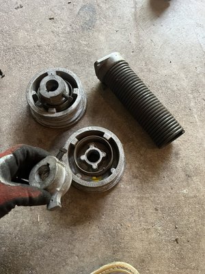Broken spring on a 1990 home. - This customer decided not to replace the wood doors and with a few new parts the door ran as good as new. Broken spring on a 1990 home. - This customer decided not to replace the wood doors and with a few new parts the door ran as good as new.