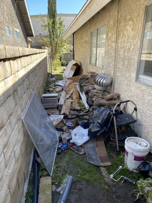 Side Yard Cleanup+ - This Is a before and after of one client that had junk taking up space in their side yard. We made quick work of the clutter and disposed of it at the dump.