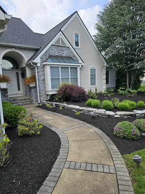 Patio installation - Upgrade your outdoor living with a professional landscape overhaul. This project showcases a custom-laid paver patio designed for maximum durability and style. To complement the stonework, we installed a selection of premium bushes and shrubs to add texture and privacy.

We finished the look with our signature deep-edge mulch beds, which not only provide a clean, modern contrast against the pavers but also protect your new plantings. At JDW Property Solutions, we handle everything from the hardscape foundation to the final horticultural touches. Ready to redefine your backyard? Request a quote today!