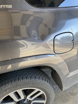 Left Quarter panel Body line dent repair - This dent repair in the quarter panel was repaired with paintless dent removal. We gain access to the dent by coming underneath the wheel liner. Dent repair was completed using glue pulling, blending, and pushing to obtain the results seen here