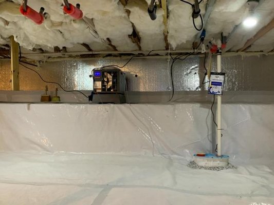 Crawl Space Encapsulation System & Dehumidification System - The crawl space of this home had minimal to no insulation, no proper dehumidifier or water drainage in place. Triple H spray foamed the rim joist of the crawl space, installed a SaniDry Sedona dehumidifier and a SmartSump to reduce moisture. SilverGlo wall insulation was installed along with the GoldSeal Encapsulation System. All these exclusive products will make this customer feel more comfortable, happy and even healthier. Crawl Space Encapsulation System & Dehumidification System - The crawl space of this home had minimal to no insulation, no proper dehumidifier or water drainage in place. Triple H spray foamed the rim joist of the crawl space, installed a SaniDry Sedona dehumidifier and a SmartSump to reduce moisture. SilverGlo wall insulation was installed along with the GoldSeal Encapsulation System. All these exclusive products will make this customer feel more comfortable, happy and even healthier.