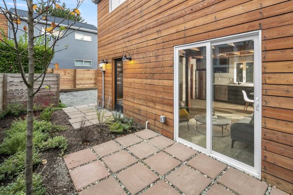 ADU – 2 Bedrooms, Reclaimed Wood Finish – South Seattle - We built this 2-story backyard DADU in South Seattle using our Roxbury floor plan — a compact and stylish 800 sq. ft. home with 2 bedrooms and 1.5 bathrooms.

The design combines modern lines with the warmth of locally sourced reclaimed wood, giving the structure a distinctive modern farmhouse aesthetic. The open-plan ground floor features hand-stained concrete floors, a bright living space, and sliding doors that open to a private patio.

The kitchen pairs stainless-steel appliances and industrial-style metal cabinetry with custom reclaimed wood beams, walls, and accents. Upstairs you'll find two cozy bedrooms, a full bath, and efficient climate control through a ductless mini-split system.

This project showcases how thoughtful material choices and smart design can elevate compact DADU living — perfect for guests, rental income, or extended family.

Key Features:

800 sq. ft. | 2 bedrooms | 1.5 bathrooms

Reclaimed wood walls, beams, and accents

Hand-stained concrete floors

Private outdoor patio

Efficient mini-split heating & cooling

Completed in South Seattle