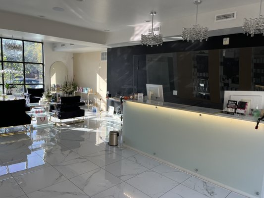 Store front repaint. - This storefront for a spa in Salt Lake City Utah needed a rebrand. We removed the velvet wallpaper and patched the drywall before painting accent walls with the companies new colors. Space looks great!
