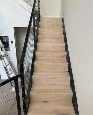 Wood installation on the staircase - We carried out the wood installation on this staircase, using real wood that allows for a perfect 45-degree angle join, eliminating the need for a stair nose. Although the nose adds beauty, a staircase without it, featuring a clean and continuous finish, is truly remarkable. Wood installation on the staircase - We carried out the wood installation on this staircase, using real wood that allows for a perfect 45-degree angle join, eliminating the need for a stair nose. Although the nose adds beauty, a staircase without it, featuring a clean and continuous finish, is truly remarkable.
