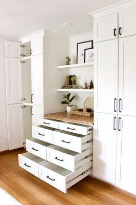 Custom Built-in Wardrobe - We removed the old standard style closet with bi-fold doors and designed this beautiful custom wardrobe to brighten up this space.