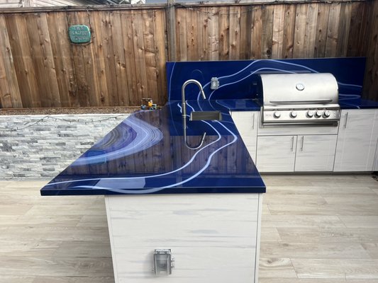 Luxury Outdoor kitchen - This remodel was done on an old abandoned back yard. This project took a lots of steps: we removed the old fence, the old concrete and some dead trees. We gutted it and put in new concrete whit nice outdoor tiles and whit drain system. The luxury out door kitchen has hot and cold water, natural gas and outdoor outlets. The owner absolutely loves cooking there now! Luxury Outdoor kitchen - This remodel was done on an old abandoned back yard. This project took a lots of steps: we removed the old fence, the old concrete and some dead trees. We gutted it and put in new concrete whit nice outdoor tiles and whit drain system. The luxury out door kitchen has hot and cold water, natural gas and outdoor outlets. The owner absolutely loves cooking there now!
