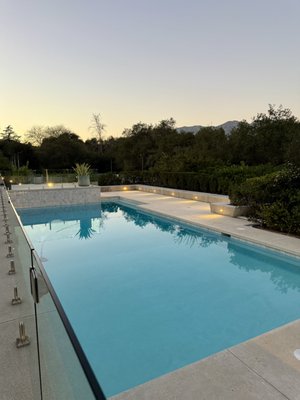 Luxury Estate Renovation – Pool Rebuild, Outdoor Kitchen & Glass Railing Hardscape | La Cañada, CA - Full luxury backyard renovation on a mid-century modern estate including complete concrete demolition, pool reconstruction, custom CMU retaining walls, built-in outdoor kitchen with stainless steel appliances, exclusive white concrete pool deck, glass panel railings, and LED step lighting. A total transformation from the ground up. Luxury Estate Renovation – Pool Rebuild, Outdoor Kitchen & Glass Railing Hardscape | La Cañada, CA - Full luxury backyard renovation on a mid-century modern estate including complete concrete demolition, pool reconstruction, custom CMU retaining walls, built-in outdoor kitchen with stainless steel appliances, exclusive white concrete pool deck, glass panel railings, and LED step lighting. A total transformation from the ground up.