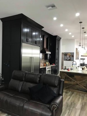 Industrial Kitchen with Farmhouse Flair - Fully Renovated Kitchen integrating reclaimed wood with copper appliances and black satin cabinetry. Industrial style with farmhouse flair. Industrial Kitchen with Farmhouse Flair - Fully Renovated Kitchen integrating reclaimed wood with copper appliances and black satin cabinetry. Industrial style with farmhouse flair.