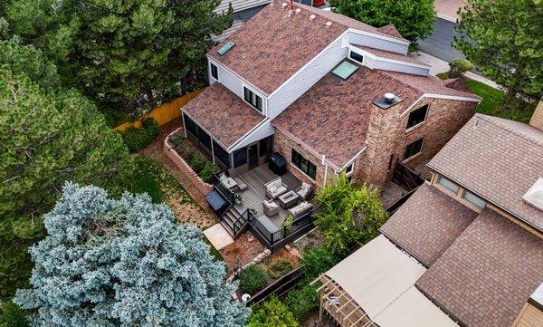 E Dartmouth Avenue Deck & Outdoor Living Remodel, Denver - Designed to extend everyday living into the backyard, this 2023 Denver renovation created a spacious approximately 600-square-foot composite deck with a new staircase, structural framing and engineered pier foundation. Dark-brown Trex decking, concealed fasteners and coordinated railings give the outdoor space a clean, durable finish, while integrated step lighting adds safety and evening ambience. The completed deck provides multiple areas for lounging, dining and entertaining alongside the home’s expansive glass doors.