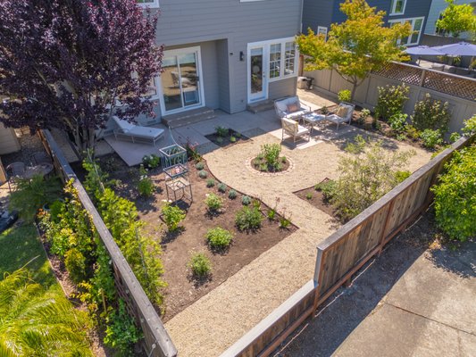 Edgewater Garden - Complete backyard transformation designed to create a functional, low-maintenance outdoor living space. This project included new concrete patio areas, custom brick steps, decorative gravel pathways and gathering areas, steel landscape edging, new planting beds, and a complete selection of trees, shrubs, roses, and accent plants. We also incorporated brick borders throughout the landscape to add definition and complement the existing home.
The finished design combines hardscape and softscape elements to create an inviting backyard with plenty of space for entertaining while maintaining a natural garden feel. Edgewater Garden - Complete backyard transformation designed to create a functional, low-maintenance outdoor living space. This project included new concrete patio areas, custom brick steps, decorative gravel pathways and gathering areas, steel landscape edging, new planting beds, and a complete selection of trees, shrubs, roses, and accent plants. We also incorporated brick borders throughout the landscape to add definition and complement the existing home.
The finished design combines hardscape and softscape elements to create an inviting backyard with plenty of space for entertaining while maintaining a natural garden feel.