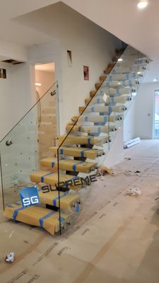 Sherman Ave - This glass railing was installed into floating wood risers steps. wich required the use of laser precise measuring tools. The challenge was to precisely locate the holes in the glass so that the standoffs can fit symmetrically on the side of the wood risers with max margin of error of 1/16" per hole per glass panel. Because of our experience in precise measurements, other local glass companies hire us to take their measurements. Sherman Ave - This glass railing was installed into floating wood risers steps. wich required the use of laser precise measuring tools. The challenge was to precisely locate the holes in the glass so that the standoffs can fit symmetrically on the side of the wood risers with max margin of error of 1/16" per hole per glass panel. Because of our experience in precise measurements, other local glass companies hire us to take their measurements.