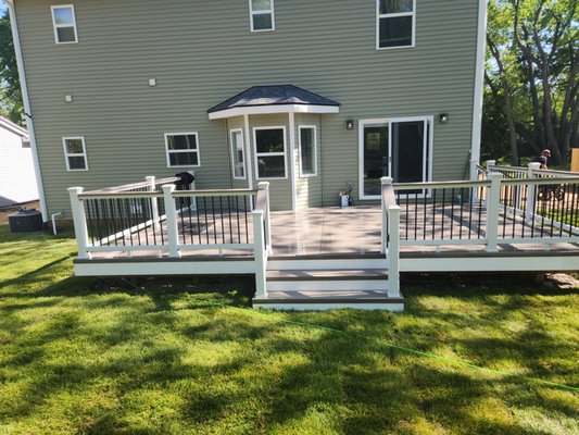 Complete tear down and rebuild a deck with PVC decking and custom aluminum railing - This deck project was a ~ 900 sqft redesigned and rebuilt deck that we completed in Oakland Twp.  The project took ~ 3-4 weeks.  The materials used were custom order PVC and Custom Color aluminum railing to match the house's aesthetics.  Whether you are building a small deck or a multitiered 2000 sq ft deck; we can build it for you!