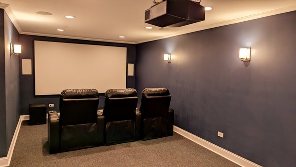 Midnight Blue Private Cinema - This intimate home cinema pairs deep blue hues with plush seating for a truly personal movie-watching experience. Designed for film enthusiasts, the room's acoustics and visuals are fine-tuned for an enveloping cinematic journey. Midnight Blue Private Cinema - This intimate home cinema pairs deep blue hues with plush seating for a truly personal movie-watching experience. Designed for film enthusiasts, the room's acoustics and visuals are fine-tuned for an enveloping cinematic journey.