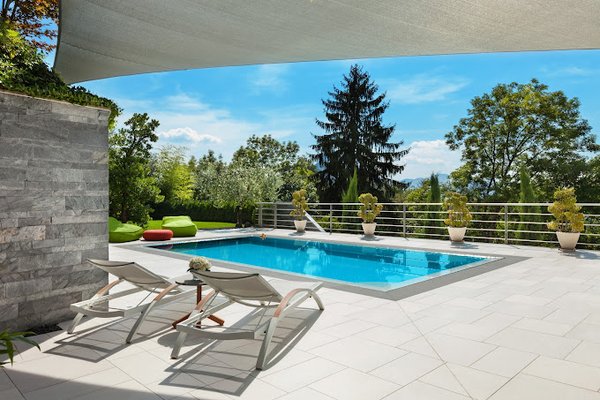 Our Dedication & Expertise - Secoma Pools Washington, based in Tacoma, is owned by Garrett, Nathan, and Tony. Established in 1973, they’ve been building in-ground pools in the region for over 50 years, focusing on Latham Fiberglass and shotcrete (concrete) pools. Their services, outlined at secomapoolswashington.com/services, include pool construction and maintenance, designed to handle the specific conditions of the Tacoma area.
They work with two primary pool types. Latham Fiberglass pools are pre-formed, installed efficiently, and built for durability with low maintenance. Fiberglass holds up well against Tacoma’s wet winters and mild summers, resisting cracks and fading. Its smooth finish cuts down on algae, which thrives in the region’s damp, debris-rich environment. Shotcrete pools are custom-built with sprayed concrete, offering flexibility in shape, depth, and features like steps or spas. Shotcrete’s strength suits Tacoma’s clay soils and minor seismic shifts, though its porous nature means more upkeep than fiberglass.
Their construction process is shaped by Tacoma’s environment. With 38 inches of annual rainfall, drainage is critical—pools are built with systems to redirect runoff and prevent soil erosion. They account for Pierce County’s diverse terrain, from flat city lots to sloped rural sites, ensuring stable bases. Fiberglass installations require exact leveling to avoid settling; shotcrete pools use rebar reinforcement tailored to soil type. Overcast skies are common, so they often suggest lighter pool finishes to enhance visibility and appeal.
Maintenance services tackle Tacoma’s realities. Evergreen debris—pine needles, leaves—clogs filters quickly, especially in fall and winter, so they provide regular cleaning and equipment checks. Rain dilutes chlorine and alters pH, particularly in wet seasons; they test and balance water chemistry to keep pools clear. Their service page breaks down fiberglass versus concrete—cost, longevity, maintenance—giving clients straightforward info to decide.
Their portfolio reflects decades of work. In Tacoma’s North End, they’ve installed fiberglass pools for small urban lots since the ‘70s. In Puyallup’s hills, shotcrete pools with retaining walls manage elevation. Features like winter covers or heaters fit Washington’s climate. They’ve built across Federal Way, Kent, and South Hill, adapting to each site’s soil, slope, and access points.
Choosing Secoma Pools Washington means relying on over 50 years of Tacoma pool-building expertise. They know local codes—Pierce County’s setbacks, drainage rules—and handle permits smoothly. Fiberglass offers efficiency; shotcrete delivers customization. Maintenance keeps pools running through the region’s seasons. Rooted in Tacoma since 1973, they’re a solid option for Puget Sound residents wanting a pool that matches the land and lasts.