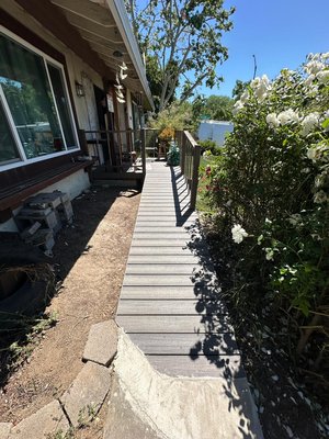 Wooden ramp/ walkway - "Project Complete!
We're excited to share the result of our latest project!
This beautiful outdoor space features:
- A welcoming porch
- A sturdy and safe ramp that provides easy access for all
- Durable and low-maintenance materials to withstand the elements
- Attractive railings and trim that add a touch of style and charm
- A seamless transition from indoors to outdoors, perfect for enjoying the fresh air and scenery
The result is a stunning and functional outdoor space that enhances the beauty and accessibility of their home. Wooden ramp/ walkway - "Project Complete!
We're excited to share the result of our latest project!
This beautiful outdoor space features:
- A welcoming porch
- A sturdy and safe ramp that provides easy access for all
- Durable and low-maintenance materials to withstand the elements
- Attractive railings and trim that add a touch of style and charm
- A seamless transition from indoors to outdoors, perfect for enjoying the fresh air and scenery
The result is a stunning and functional outdoor space that enhances the beauty and accessibility of their home.