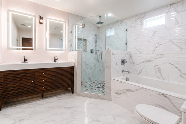 Bathroom Remodel by Vivid Homes, Leading Construction Companies in Simi Valley, CA - Vivid Homes, a name synonymous with quality construction and the finest remodeling contractors, is excited to unveil a recently completed bathroom remodel in Simi Valley, CA. This project stands as a testament to our expertise as a bathroom remodel contractor and our commitment to home remodeling excellence.
Entering this newly renovated space, you're greeted by an expansive vanity with a rich, walnut finish that offers both warmth and modern sophistication. The clean lines of the cabinetry and contemporary hardware reflect our role as a forward-thinking contractor, ensuring every design element is on trend.
The bathroom boasts a luxurious walk-in shower, featuring glass enclosures that provide a spacious feel. The exquisite marble-like tiles deliver an opulent look, making it a focal point of the remodel. We’ve balanced beauty with functionality by including a deep soaking tub, perfect for those moments of relaxation.
As a general contractor specializing in both bathroom and kitchen remodels, Vivid Homes ensures that every inch of your space is thoughtfully considered. Our position among top construction companies is solidified by our dedication to craftsmanship and client satisfaction.
Simi Valley residents looking for a bathroom remodel or any home renovation can rely on our team of general contractors to create a space that’s not just built, but meticulously designed and tailored to your lifestyle.
Imagine a bathroom that’s crafted just for you. Contact Vivid Homes today, the contractors who blend artistry with expertise to create spaces that inspire. Schedule your consultation and let us build not just a bathroom, but a sanctuary, right in the heart of Simi Valley, CA. Your luxurious retreat awaits! Bathroom Remodel by Vivid Homes, Leading Construction Companies in Simi Valley, CA - Vivid Homes, a name synonymous with quality construction and the finest remodeling contractors, is excited to unveil a recently completed bathroom remodel in Simi Valley, CA. This project stands as a testament to our expertise as a bathroom remodel contractor and our commitment to home remodeling excellence.
Entering this newly renovated space, you're greeted by an expansive vanity with a rich, walnut finish that offers both warmth and modern sophistication. The clean lines of the cabinetry and contemporary hardware reflect our role as a forward-thinking contractor, ensuring every design element is on trend.
The bathroom boasts a luxurious walk-in shower, featuring glass enclosures that provide a spacious feel. The exquisite marble-like tiles deliver an opulent look, making it a focal point of the remodel. We’ve balanced beauty with functionality by including a deep soaking tub, perfect for those moments of relaxation.
As a general contractor specializing in both bathroom and kitchen remodels, Vivid Homes ensures that every inch of your space is thoughtfully considered. Our position among top construction companies is solidified by our dedication to craftsmanship and client satisfaction.
Simi Valley residents looking for a bathroom remodel or any home renovation can rely on our team of general contractors to create a space that’s not just built, but meticulously designed and tailored to your lifestyle.
Imagine a bathroom that’s crafted just for you. Contact Vivid Homes today, the contractors who blend artistry with expertise to create spaces that inspire. Schedule your consultation and let us build not just a bathroom, but a sanctuary, right in the heart of Simi Valley, CA. Your luxurious retreat awaits!