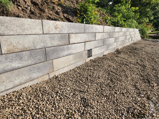 unilock retaining wall - Building a beach on the fox river. Using unilock retaining wallblocks. Two hundred and sixty pounds a piece. unilock retaining wall - Building a beach on the fox river. Using unilock retaining wallblocks. Two hundred and sixty pounds a piece.