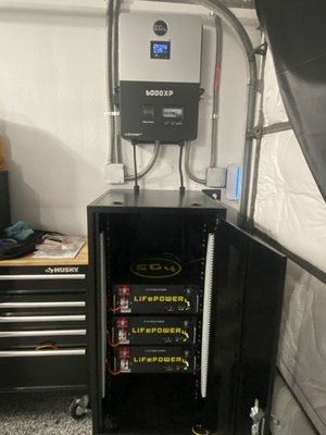 Off grid solar with battery installation converting garage music studio with added quad circuits and upgrade of all outlets to quad outlets - The homeowner initially wanted to have an off grid charging station for his multiple e-bike collection. That turned into being able to operate his entire garage turned music studio. We also added extra circuits and upgraded all existing circuits to quad outlets, as well as operating his homes fridge completely off grid.
This job came in seamlessly, worked exceptionally, and had far exceeded homeowners expectations.
After several months of operation he decided the energy production worked so well that he wanted to sell back to the utility and since the existing inverter did not have that capability he decided to upgrade his inverter to an 18k eG4 hybrid inverter to be able to sell his production back while still having off-grid capability. We have since swapped out that inverter and helped navigate his interconnection agreement with his utility and is now successfully operating in off setting his energy cost while selling back to the grid while still having the option for his garage and refrigerator to be completely off grid. Photos have been added.
And he plans on adding more panels in the future for even more savings/energy production Off grid solar with battery installation converting garage music studio with added quad circuits and upgrade of all outlets to quad outlets - The homeowner initially wanted to have an off grid charging station for his multiple e-bike collection. That turned into being able to operate his entire garage turned music studio. We also added extra circuits and upgraded all existing circuits to quad outlets, as well as operating his homes fridge completely off grid.
This job came in seamlessly, worked exceptionally, and had far exceeded homeowners expectations.
After several months of operation he decided the energy production worked so well that he wanted to sell back to the utility and since the existing inverter did not have that capability he decided to upgrade his inverter to an 18k eG4 hybrid inverter to be able to sell his production back while still having off-grid capability. We have since swapped out that inverter and helped navigate his interconnection agreement with his utility and is now successfully operating in off setting his energy cost while selling back to the grid while still having the option for his garage and refrigerator to be completely off grid. Photos have been added.
And he plans on adding more panels in the future for even more savings/energy production