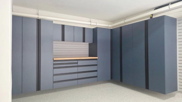 A Coral Gables garage with floor-to-ceiling navy cabinets wrapping the corner, a slatwall workbench center, and a flake epoxy floor. - There is a particular kind of satisfaction in a garage that is finished correctly — not merely outfitted, but composed. This Coral Gables project is exactly that. What began as a raw, sub-level garage, with structural columns, exposed overhead conduit, and the usual concrete-and-clutter starting point, became a clean, deliberate, fully resolved room. The kind of space where every line lands where it should and nothing feels like an afterthought.
The work centers on a continuous run of custom cabinetry in a deep navy-blue finish, carried floor to ceiling and wrapped around the corner of the room. Wrapping a corner is where craftsmanship shows itself. It is easy to set a bank of cabinets along a single flat wall; it is considerably harder to turn the corner cleanly, hold the reveal lines consistent on both planes, and keep the doors and seams reading as one uninterrupted piece. Here the transition is seamless. The eye follows the cabinetry around the room without catching on a single misaligned edge.
At the heart of the run sits a solid butcher-block workbench, its warm wood grain set against the cool navy like a deliberate counterpoint. Above it, a section of slatwall serves as a working backsplash, ready to carry hooks, bins, and tools that can be rearranged as needs change. Below, a stack of full-extension bank drawers keeps smaller hardware sorted and out of sight. Overhead, upper cabinets close the composition, using the full vertical height of the room rather than leaving dead space near the ceiling. Every cubic foot is accounted for.
The cabinets themselves are powder-coated and moisture-resistant — a finish chosen for South Florida, where humidity is relentless and a lesser material would swell, warp, or cloud within a season. The flush doors sit tight and even, the hardware is integrated rather than bolted on as an afterthought, and the matte navy holds its depth under the garage lighting without going flat or shiny. It is a finish that reads as furniture, not as utility.
On the adjacent wall, a full-width slatwall panel system extends the storage vertically. Bikes, ladders, long-handled tools, and seasonal equipment lift off the floor and onto the wall, fully adjustable and endlessly reconfigurable. The panels are mounted dead level and run wall to wall, framing the room and reinforcing the same clean horizontal logic that the cabinetry establishes.
Underfoot, the entire floor is finished in our flake epoxy coating. Before a single coat went down, the slab was diamond-ground to open the concrete and guarantee a permanent mechanical bond — the unglamorous step that separates a floor that lasts from one that peels in two years. The result is a seamless, slip-resistant surface in a soft neutral flake that brightens the whole room, hides dust, resists hot tires and chemical stains, and wipes clean with almost no effort. The coating runs tight to the cabinet bases and up against the columns with crisp, controlled edges — no overspray, no ragged transitions.
What ties the project together is restraint. The navy, the wood, the soft gray slatwall, and the speckled floor form a tight, intentional palette. Nothing competes. The exposed building structure that the room started with has been absorbed into a design that feels calm and complete. This is what nearly two decades of doing this work looks like — measured twice, installed once, and finished to a standard the homeowner will still be proud of in ten years.
A garage like this is not just storage. It is a finished room that happens to hold cars and gear, executed with the same care a great kitchen or closet would receive. Look closely and the discipline is in the details: cabinet faces sit plumb and co-planar across the entire run, the corner returns are mitered clean, the toe-kicks align, and the gaps between doors are uniform from one end of the room to the other. Those are the things you stop noticing precisely because they were done right.
That is the standard we bring to every Coral Gables project, and it is exactly what these photos show. A Coral Gables garage with floor-to-ceiling navy cabinets wrapping the corner, a slatwall workbench center, and a flake epoxy floor. - There is a particular kind of satisfaction in a garage that is finished correctly — not merely outfitted, but composed. This Coral Gables project is exactly that. What began as a raw, sub-level garage, with structural columns, exposed overhead conduit, and the usual concrete-and-clutter starting point, became a clean, deliberate, fully resolved room. The kind of space where every line lands where it should and nothing feels like an afterthought.
The work centers on a continuous run of custom cabinetry in a deep navy-blue finish, carried floor to ceiling and wrapped around the corner of the room. Wrapping a corner is where craftsmanship shows itself. It is easy to set a bank of cabinets along a single flat wall; it is considerably harder to turn the corner cleanly, hold the reveal lines consistent on both planes, and keep the doors and seams reading as one uninterrupted piece. Here the transition is seamless. The eye follows the cabinetry around the room without catching on a single misaligned edge.
At the heart of the run sits a solid butcher-block workbench, its warm wood grain set against the cool navy like a deliberate counterpoint. Above it, a section of slatwall serves as a working backsplash, ready to carry hooks, bins, and tools that can be rearranged as needs change. Below, a stack of full-extension bank drawers keeps smaller hardware sorted and out of sight. Overhead, upper cabinets close the composition, using the full vertical height of the room rather than leaving dead space near the ceiling. Every cubic foot is accounted for.
The cabinets themselves are powder-coated and moisture-resistant — a finish chosen for South Florida, where humidity is relentless and a lesser material would swell, warp, or cloud within a season. The flush doors sit tight and even, the hardware is integrated rather than bolted on as an afterthought, and the matte navy holds its depth under the garage lighting without going flat or shiny. It is a finish that reads as furniture, not as utility.
On the adjacent wall, a full-width slatwall panel system extends the storage vertically. Bikes, ladders, long-handled tools, and seasonal equipment lift off the floor and onto the wall, fully adjustable and endlessly reconfigurable. The panels are mounted dead level and run wall to wall, framing the room and reinforcing the same clean horizontal logic that the cabinetry establishes.
Underfoot, the entire floor is finished in our flake epoxy coating. Before a single coat went down, the slab was diamond-ground to open the concrete and guarantee a permanent mechanical bond — the unglamorous step that separates a floor that lasts from one that peels in two years. The result is a seamless, slip-resistant surface in a soft neutral flake that brightens the whole room, hides dust, resists hot tires and chemical stains, and wipes clean with almost no effort. The coating runs tight to the cabinet bases and up against the columns with crisp, controlled edges — no overspray, no ragged transitions.
What ties the project together is restraint. The navy, the wood, the soft gray slatwall, and the speckled floor form a tight, intentional palette. Nothing competes. The exposed building structure that the room started with has been absorbed into a design that feels calm and complete. This is what nearly two decades of doing this work looks like — measured twice, installed once, and finished to a standard the homeowner will still be proud of in ten years.
A garage like this is not just storage. It is a finished room that happens to hold cars and gear, executed with the same care a great kitchen or closet would receive. Look closely and the discipline is in the details: cabinet faces sit plumb and co-planar across the entire run, the corner returns are mitered clean, the toe-kicks align, and the gaps between doors are uniform from one end of the room to the other. Those are the things you stop noticing precisely because they were done right.
That is the standard we bring to every Coral Gables project, and it is exactly what these photos show.