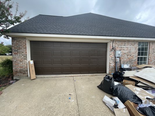 Stamped Carriage House Install - One of our valued customers purchased a "fixer-upper" and wanted a new look for their home. This carriage house style door complimented the brick style of the exterior.
