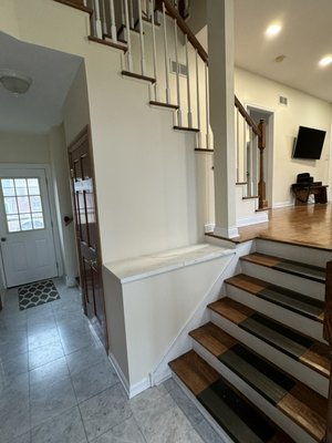 Stair wall remodeling - After limestone demolition, new wall structure was built, quartz installed on top.