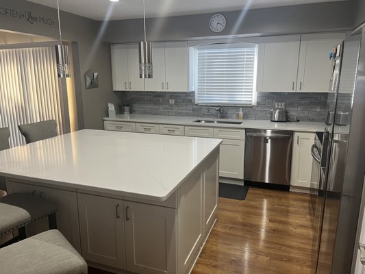White Shaker Kitchen + Island Remodel - The customer wanted to update their backwall kitchen layout and create a modern looking kitchen. They were also interested in putting in a island to increase their counterspace and create an area for people to hangout. 

Full kitchen remodel looks great and updated the house.