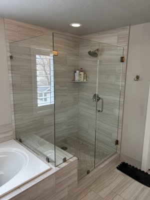 Before and after install. Salt Lake City, Utah 2025 - The old metal-framed shower enclosure was removed and replaced with a clear, frameless glass for a seamless, modern look. The new glass opens up the space, showing off the tile work and giving the bathroom a clean, updated feel. View photo 3 for the before picture.