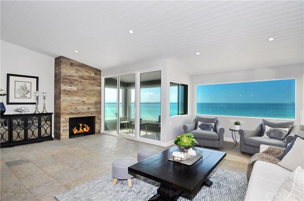 SOLD: 6619 E Seaside Walk - This gorgeous completely custom remodeled 3 bed, 3.5 bath chic Oceanfront home is the ultimate beach retreat! Hand laid stone floors throughout home. Second floor living space includes sliding doors out to Oceanfront patio, endless views, spacious living area with fireplace. Great room floor plan with custom cabinets and countertops in gourmet chefs kitchen. Entertain at kitchen island and dine in the comfortable eating area. Oversized master bedroom with large bathroom, walk in closet and separate area perfect for an office.

A large balcony off of the master offers privacy and leads to winding staircase to rooftop deck. Lower level includes large bonus room with wet bar area and entrance to beach. One ensuite bedroom and bath and an additional large bedroom with separate bath also located on lower level.