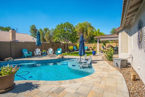 Forge Remodel Retreat - The pool was remodeled to add a baja shelf, a new interior and waterline tile. The backyard we added a new large set paver with synthetic turf and updated rock to bring the entire space to life. The space is inviting and vibrant for the entire family to enjoy!