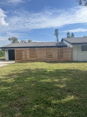Semi privacy horizontal fence with 2” gap and then stained with black. Built in Southgate, Sarasota. - This house needed privacy for the front windows from the road outside. We built a semi-privacy fence and then stained it with black stain to match the new paint on the house. This gave the house the privacy it needed plus a thoroughly modern look! Semi privacy horizontal fence with 2” gap and then stained with black. Built in Southgate, Sarasota. - This house needed privacy for the front windows from the road outside. We built a semi-privacy fence and then stained it with black stain to match the new paint on the house. This gave the house the privacy it needed plus a thoroughly modern look!