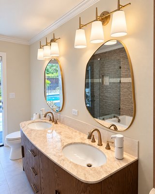 Guests bathroom renovation in Danville - We LOVE this project: a custom curved double vanity, arched open shelving, natural stone countertops, and brushed gold fixtures. Plus a new paver patio right outside. 🛁🌿

Full scope: vanity & cabinetry install, countertops, tile, fixtures, toilet, lighting.

Planning a remodel in Contra Costa County? Send us a DM for a free estimate or give us a call at (925)844-4539.

#bayareacontractor #bayarearemodeling #walnutcreekca #danville #bathroomremodel
