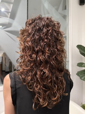 Custom Curly Cuts - A custom curly haircut is a tailored haircut specifically designed to enhance and complement the natural curl pattern of your hair. It involves a personalized approach to cutting and shaping curly hair to achieve the best results for your unique curl type, texture, and desired style.