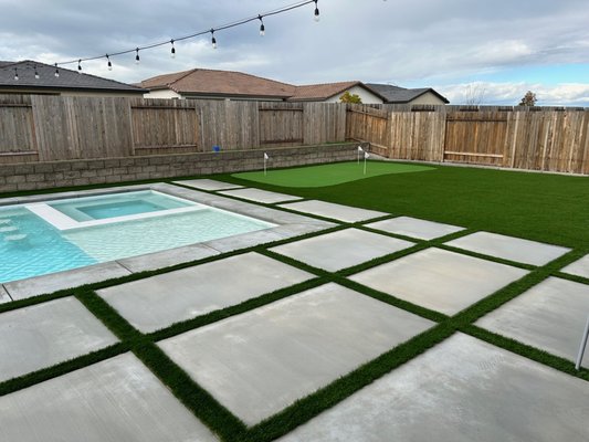 Backyard Artificial Turf & Custom Hardscape - Our customer came us after they completed their new backyard pool wanting a full artificial turf and custom concrete pavers installation. They were struggling with maintenance of their yard previously, and wanted a new solution for entertaining, family events and an easy solution with multiple pets. We installed all new custom concrete pavers with artificial turf inlays, along with a large section of artificial turf for kids and pets. We also installed a putting green for everyone to enjoy at get togethers. The customer has been very happy with the outcome and we'd be happy to handle your backyard renovation next! Reach out to get a free in person consultation. Backyard Artificial Turf & Custom Hardscape - Our customer came us after they completed their new backyard pool wanting a full artificial turf and custom concrete pavers installation. They were struggling with maintenance of their yard previously, and wanted a new solution for entertaining, family events and an easy solution with multiple pets. We installed all new custom concrete pavers with artificial turf inlays, along with a large section of artificial turf for kids and pets. We also installed a putting green for everyone to enjoy at get togethers. The customer has been very happy with the outcome and we'd be happy to handle your backyard renovation next! Reach out to get a free in person consultation.