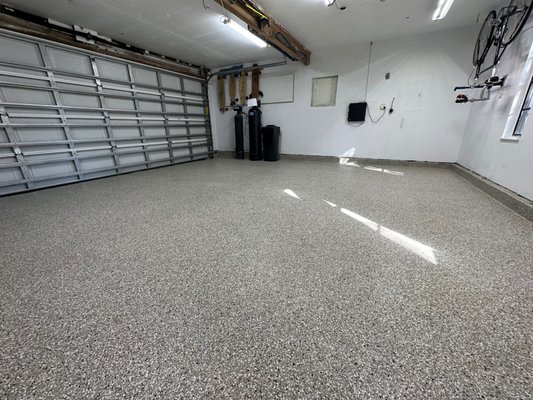 2 Car Flake Garage - We took 40 years off the age of the garage," Said our Client, on the day of completion. All of the old stains, paint spills, and cracks were taken care of. This left the customer with a beautiful space that they planned to use more as an indoor/outdoor area now that the floor was finally clean. They chose a moisture vapor barrier as their base-coat, Creekbed flake coloring, and a UV stable Poly-aspartic top-coat for longevity. We expect this floor to look like new for years to come. 2 Car Flake Garage - We took 40 years off the age of the garage," Said our Client, on the day of completion. All of the old stains, paint spills, and cracks were taken care of. This left the customer with a beautiful space that they planned to use more as an indoor/outdoor area now that the floor was finally clean. They chose a moisture vapor barrier as their base-coat, Creekbed flake coloring, and a UV stable Poly-aspartic top-coat for longevity. We expect this floor to look like new for years to come.