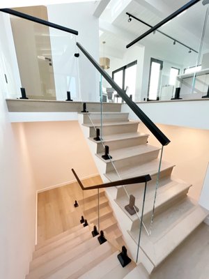Manhattan Beach Project - From Outdated to Outstanding: A Staircase Transformation
This home’s staircase underwent a stunning transformation, replacing its old, traditional railings with a sleek, modern glass railing system. The previous design, with bulky metal bars, felt heavy and obstructed the openness of the space. By introducing frameless glass panels and minimalist black hardware, the entire area now feels brighter, more spacious, and effortlessly elegant.
The new glass railing not only enhances safety but also preserves sightlines, allowing natural light to flow seamlessly throughout the home. The combination of clean lines and high-end finishes adds a touch of contemporary sophistication, elevating the overall aesthetic.
A perfect blend of form and function, this upgrade showcases how modern glass railings can redefine a space, creating a refined, airy, and luxurious atmosphere. Manhattan Beach Project - From Outdated to Outstanding: A Staircase Transformation
This home’s staircase underwent a stunning transformation, replacing its old, traditional railings with a sleek, modern glass railing system. The previous design, with bulky metal bars, felt heavy and obstructed the openness of the space. By introducing frameless glass panels and minimalist black hardware, the entire area now feels brighter, more spacious, and effortlessly elegant.
The new glass railing not only enhances safety but also preserves sightlines, allowing natural light to flow seamlessly throughout the home. The combination of clean lines and high-end finishes adds a touch of contemporary sophistication, elevating the overall aesthetic.
A perfect blend of form and function, this upgrade showcases how modern glass railings can redefine a space, creating a refined, airy, and luxurious atmosphere.