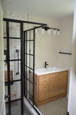 Major Functionality and Style Bathroom Upgrade - This bathroom was a major upgrade in terms of functionality and style. Many aspects of the bathroom made it less functional- the size of the cabinet, the baseboard radiator, and the shower door location. We addressed all these concerns and gave the bathroom a revamp to accommodate the family's needs. Major Functionality and Style Bathroom Upgrade - This bathroom was a major upgrade in terms of functionality and style. Many aspects of the bathroom made it less functional- the size of the cabinet, the baseboard radiator, and the shower door location. We addressed all these concerns and gave the bathroom a revamp to accommodate the family's needs.