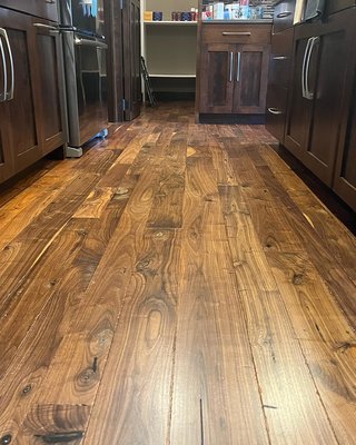 Walnut Refinish 2022 - This refinish took a lot of attention to detail and heavy sanding to get the floor flat and free of the bevels. We sanded the floor flat and until it was free of visible scratches. It was trowel filled with wood filler and cleaned well before finishing. A 1 coat penetrating oil application was applied to keep the raw wood feel, add some color, and protect the floor from damage. Walnut Refinish 2022 - This refinish took a lot of attention to detail and heavy sanding to get the floor flat and free of the bevels. We sanded the floor flat and until it was free of visible scratches. It was trowel filled with wood filler and cleaned well before finishing. A 1 coat penetrating oil application was applied to keep the raw wood feel, add some color, and protect the floor from damage.