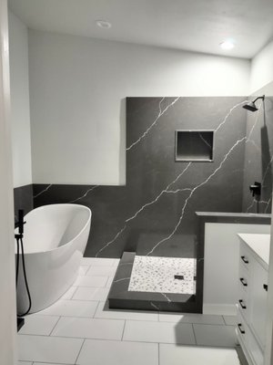 Bathroom Remodel - This remodel was done on an outdated bathroom that we brought back to life. There was a bunch of old tile, a shower insert, and laminate counter vanities. We installed a quartz shower with new tile shower pan, new tile floors, and a freestanding tub. Bathroom Remodel - This remodel was done on an outdated bathroom that we brought back to life. There was a bunch of old tile, a shower insert, and laminate counter vanities. We installed a quartz shower with new tile shower pan, new tile floors, and a freestanding tub.
