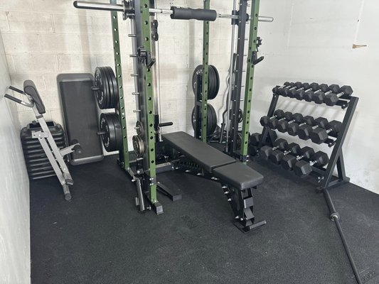Full Delta Fitness Garage Gym - This garage gym may seem modest, but this gym will carry you through any workout you can imagine! Our client Barb was very happy with her full setup of Delta Fitness Onyx Bumper plates, Illinois Bar, Rubber Flooring, Dumbbells and Dumbbell Rack. Full Delta Fitness Garage Gym - This garage gym may seem modest, but this gym will carry you through any workout you can imagine! Our client Barb was very happy with her full setup of Delta Fitness Onyx Bumper plates, Illinois Bar, Rubber Flooring, Dumbbells and Dumbbell Rack.