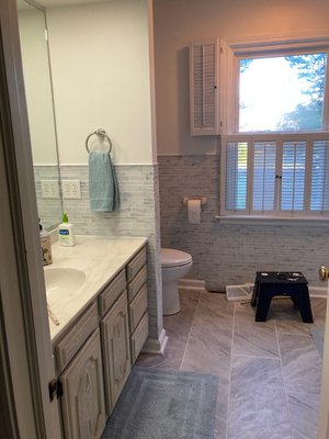 master bathroom, novelty, oh - This homeowner decided it was time to update her master bathroom to a new look so we sat and discussed all new age products available. First she wanted a new 48"x60" mirror. She then expressed how the octagon tiles on the floor weren't very attractive so we replaced them with 12"x24" tile. Next came the shower door, which she didn't like when moving in. It had a floral pattern with a Polished Chrome track and trim. She decided a new rain textured, glass sliding bathtub door with Satin Nickel track and trim would be the right choice. After seeing the new products, she decided she wanted to install a glass mosaic backsplash 48"aff (above finished floor) encased by White Schluter Tile Edge Trim. We were almost there. Finally, the walls needed the wallpaper removed and a fresh coat of paint. Alabaster she knew would bring it altogether, making this bathroom a great project that she can enjoy for the remainder of her time in the home. Thanks for the opportunity to help you with your bathroom! It's homeowners like this that really make us enjoy our careers in this field.