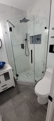 Bathroom Remodel - “From outdated to outstanding! 🚿✨ This bathroom transformation started with old cast iron plumbing, which we replaced with durable PVC for the toilet and shower. We then built a sleek, modern space featuring a frameless glass shower, large-format marble-look tile, hexagon mosaic shower floor, a floating vanity with a bold vessel sink, matte black fixtures, and updated lighting. The result: a clean, modern design that combines style, function, and durability.” Bathroom Remodel - “From outdated to outstanding! 🚿✨ This bathroom transformation started with old cast iron plumbing, which we replaced with durable PVC for the toilet and shower. We then built a sleek, modern space featuring a frameless glass shower, large-format marble-look tile, hexagon mosaic shower floor, a floating vanity with a bold vessel sink, matte black fixtures, and updated lighting. The result: a clean, modern design that combines style, function, and durability.”