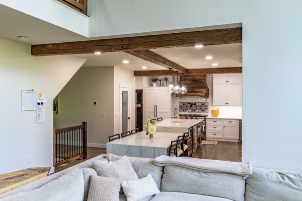 Modern Farmhouse Kitchen Renovation - We took a dark and dated kitchen and installed new Amish built custom cabinetry, custom reclaimed barnwood beams, hood and island, engineered quartz countertops, a 48" range and built in refrigerator (panel ready, so it blends in with the cabinetry), engineered hardwood floors, a new large double sliding back door, new fireplace and beams and light fixture in the great room. We removed glass block and installed reclaimed barnwood railing. The front door was refinished. New tile in the bathroom, laundry room, and on the stairs tie to the decorative backsplash behind the range. Modern Farmhouse Kitchen Renovation - We took a dark and dated kitchen and installed new Amish built custom cabinetry, custom reclaimed barnwood beams, hood and island, engineered quartz countertops, a 48" range and built in refrigerator (panel ready, so it blends in with the cabinetry), engineered hardwood floors, a new large double sliding back door, new fireplace and beams and light fixture in the great room. We removed glass block and installed reclaimed barnwood railing. The front door was refinished. New tile in the bathroom, laundry room, and on the stairs tie to the decorative backsplash behind the range.
