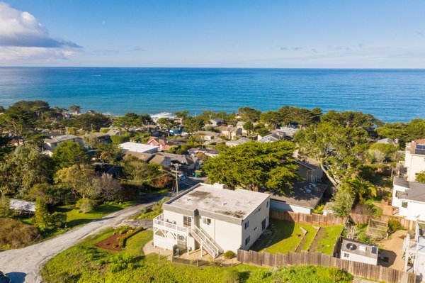 391 11th Street, Montara - Relish the serenity of the Coast with majestic ocean views! With a fantastic location approximately 15 miles south of San Francisco & perched on Montara's 11th Street, find peaceful Coastal living with surroundings of mountains & ocean air. From the living room of this reverse floor plan home, enjoy sweeping views & the warmth of a cozy wood-burning fireplace while conveniently open to the dining room & kitchen, complimented by Bamboo wood floors & complete with stainless steel appliances, plenteous cabinet space as well as an attached balcony. The master suite, 2 additional bedrooms & a full bathroom are upstairs, while the lower level features an open area with potential for your space needs as well as access to the backyard of this 5,300-/+ sq ft lot - ready for you to make your own. Oversized 2-car garage includes laundry hookups & work bench. Enjoy close proximity to beaches & hiking trails in addition to the Coastside's Pillar Point Harbor & commute routes for the SF Peninsula.