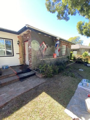 Exterior Stucco application - Applied an exterior skim coat over brick wall with polybond and finalized with a sand finished coat
