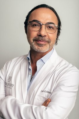 Dr. David Amron - Dr. David Amron is a board-certified dermatologic surgeon, as well as the founder and medical director of the Roxbury Institute. A veteran in the industry for over 25 years, he’s built his reputation on impeccable patient care and flawless results, and is highly sought after by exclusive clients around the globe for his refined, tailored and scientific approach to liposuction.
Raised in Southern California, Dr. Amron attended both the University of California at Los Angeles (UCLA) and the University of California at San Diego (UCSD), where he received his bachelor’s degree in biology. From there, he achieved his medical degree from the esteemed Albert Einstein College of Medicine in New York, before returning to California to finish his residency at UCSD and complete a rigorous research fellowship at UCLA.
Actively involved in his field, Dr. Amron has had numerous articles published in medical journals, authored chapters in medical textbooks on dermatologic surgery, and regularly instructs his peers on the art and science of liposculpture. One of the top dermatologic surgeons Beverly Hills has to offer, he’s a regular fixture in the media, contributing to major news outlets such as the Wall Street Journal, The Los Angeles Times and Cosmopolitan. He was also the host of a popular Los Angeles radio show dedicated to educating the public on cosmetic surgery, “A Cut Above.” Dr. David Amron - Dr. David Amron is a board-certified dermatologic surgeon, as well as the founder and medical director of the Roxbury Institute. A veteran in the industry for over 25 years, he’s built his reputation on impeccable patient care and flawless results, and is highly sought after by exclusive clients around the globe for his refined, tailored and scientific approach to liposuction.
Raised in Southern California, Dr. Amron attended both the University of California at Los Angeles (UCLA) and the University of California at San Diego (UCSD), where he received his bachelor’s degree in biology. From there, he achieved his medical degree from the esteemed Albert Einstein College of Medicine in New York, before returning to California to finish his residency at UCSD and complete a rigorous research fellowship at UCLA.
Actively involved in his field, Dr. Amron has had numerous articles published in medical journals, authored chapters in medical textbooks on dermatologic surgery, and regularly instructs his peers on the art and science of liposculpture. One of the top dermatologic surgeons Beverly Hills has to offer, he’s a regular fixture in the media, contributing to major news outlets such as the Wall Street Journal, The Los Angeles Times and Cosmopolitan. He was also the host of a popular Los Angeles radio show dedicated to educating the public on cosmetic surgery, “A Cut Above.”