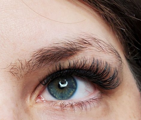 Volume Lashes - Volume lashes are applied using a special technique that uses 2 or more thinner lashes to create a fluffy fan. The fan is then applied to each individual lash. The results are full and fluffy. Perfect for those with sparse natural lashes and those who want a lot of fullness.