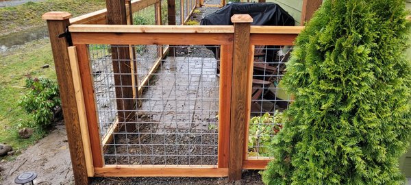Welded wire trimmed and framed in cedar style - This customer needed a fence to keep their small dogs safe and secure (North Bend, WA). Welded wire trimmed and framed in cedar style - This customer needed a fence to keep their small dogs safe and secure (North Bend, WA).