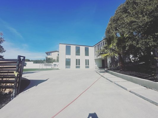 Said Residence - Our expansive concrete driveway, a grand project, embodies durability and aesthetic finesse. Employing top cast technique, it showcases the raw beauty of aggregates, while precision saw-cut joints add intricate patterns. With a dual entrance, it harmonizes functionality and elegance, welcoming vehicles seamlessly into a meticulously crafted landscape. Said Residence - Our expansive concrete driveway, a grand project, embodies durability and aesthetic finesse. Employing top cast technique, it showcases the raw beauty of aggregates, while precision saw-cut joints add intricate patterns. With a dual entrance, it harmonizes functionality and elegance, welcoming vehicles seamlessly into a meticulously crafted landscape.